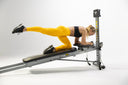 Woman doing a kneeling glute kickback on the Total Gym FIT Anniversary Edition