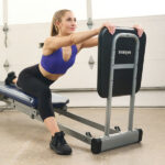 Model stretching on Total Gym Deluxe Squat Stand